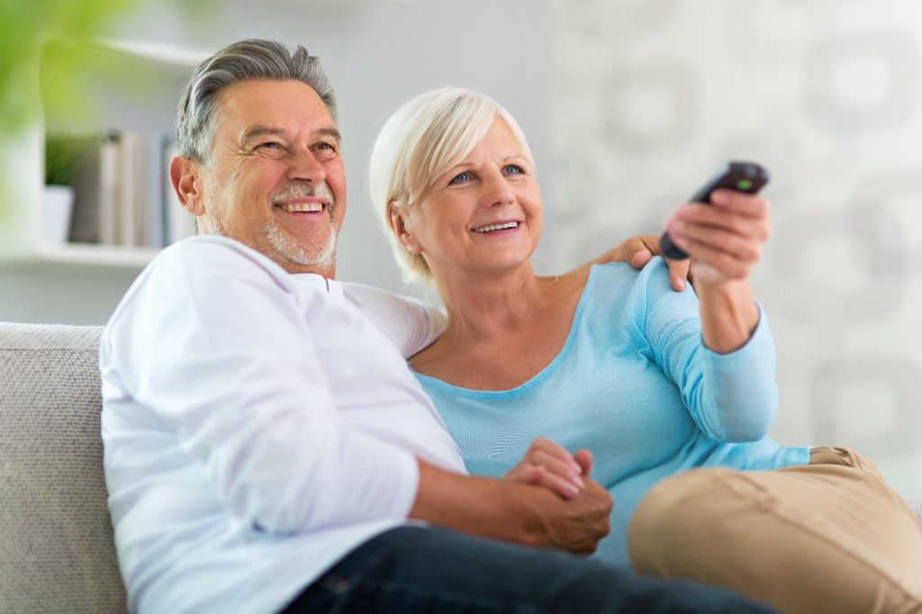 senior couple with remote control