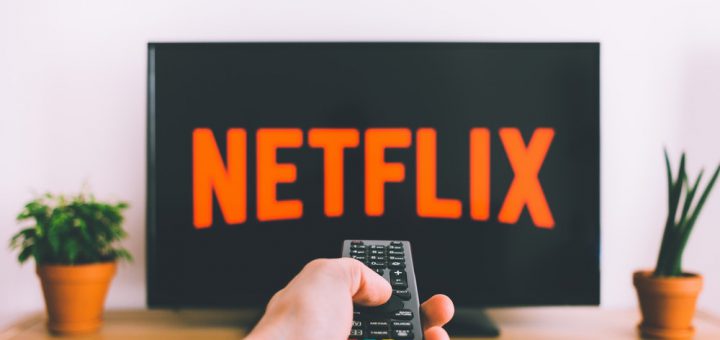 person using a remote to streaming netflix