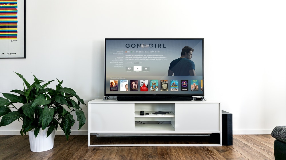 Flat Screen TV on White Wooden TV Rack in Living Room
