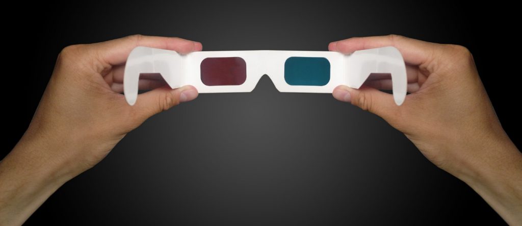 man hand holding 3D glasses